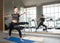 Beautiful caucasion white woman doing yoga exercises in fitness gym.A young woman exercising near the mirror