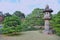 Beautiful cedar tree and stone lantern in traditional japanese garden in Tokyo. Relax, tranquility and meditation.