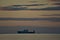 Beautiful centered early morning view of alone sea truck ferry ship in Irish Sea seen from Blackrock Beach, Dublin, Ireland