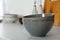 Beautiful ceramic bowls on white countertop in kitchen. Space for text