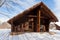 Beautiful chalet of wooden frame in the winter landscape.