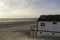 Beautiful characteristic wooden house along the beach side at Costa da Caparica in Lisbon, Portugal. Small village on the beach at