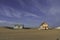 Beautiful characteristic wooden house along the beach side at Costa da Caparica in Lisbon, Portugal. Small village on the beach at