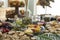 Beautiful charcuterie table set up for lunch with meats, cheeses, sandwiches, and vegetables