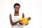 Beautiful cheerful african woman standing and holding exotic fruits