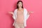 Beautiful cheerful dark haired european pregnant woman in comfy outfit spreading hands with astonished expression. Mother don`t