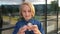 Beautiful cheerful school girl playing with a gold fidget spinner. A popular trendy toy.