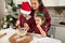 Beautiful cheerful stunning delighted young Hispanic mother and her adorable kids, son and daughter cooking together in the home