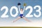 Beautiful cheerleader girl jumping with 2023 number