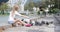 A beautiful child feeds pigeons bread at the lake in summer.