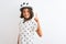 Beautiful child girl wearing security bike helmet standing over isolated white background pointing finger up with successful idea
