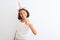 Beautiful child girl wearing unicorn diadem standing over isolated white background doing happy thumbs up gesture with hand