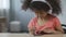 Beautiful child with headset listening to music and viewing photos on cellphone