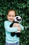 Beautiful child hugging plush panda and smiling at camera