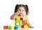 Beautiful child plays building a castle with cubes