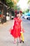 Beautiful child wearing red Chinese clothes takes walk on holiday of traditional Chinese New Year.