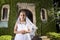 Beautiful child in white dress outside chapel door