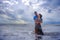 beautiful Chinese Asian couple with woman hug her boyfriend romantic and cuddle on the beach smiling in dating and romance