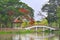 Beautiful Chinese Garden with lovely bridge and red flowers