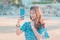 Beautiful Chinese lookng Woman is taking selfie on a summer beach