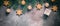 Beautiful Christmas background border. Spruce branches are decorated with gold balls and stars on an abstract rustic background.