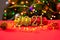 A beautiful Christmas card featuring 2021 figures and a gold ribbon on a red background with a side bokeh at the back. New Year,