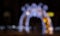 Beautiful Christmas Defocusing Arch illuminated by LED lights in a public park at night