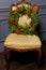 Beautiful Christmas green festive wreath from the Christmas tree lying on a chair