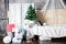 Beautiful Christmas interior design. Room decorated with Christmas tree, gifts, different boxes and comfortable sofa. Concept