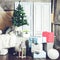 Beautiful Christmas interior design. Room decorated with Christmas tree, gifts, different boxes and comfortable sofa, toned image