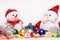 Beautiful Christmas and New Year composition with Santa Claus and snowman in red hats and scarves in front colored toys, candys