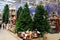 Beautiful Christmas and New Year tree, toys, decorations in toy store. Funny Santa Claus, snowmen, dolls in supermarket. Festive