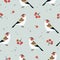 Beautiful Christmas seamless pattern with European goldfinch birds and rowan berries. Cute Scandinavian winter design