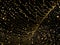 Beautiful Christmas sparkling golden garland lights on black night sky background. Holiday city decoration for New Years