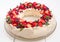 Beautiful Christmas wreath shaped Pavlova cake made of french meringue, whipped cream, decorated with fresh berries