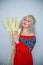 Beautiful Chubby Blonde Girl In Red Dress With Wheat bouquet on white studio solid background