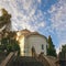 Beautiful church on background of blue sky with white clouds. Montenegro, Kamenari town. View of Church of Sveta Nedjelja