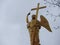 Beautiful Church near the water in the estate Grebnevo in the Moscow region. The figure of the Archangel holding the cross on the