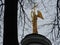 Beautiful Church near the water in the estate Grebnevo in the Moscow region. The figure of the Archangel holding the cross on the