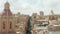 Beautiful Church Towers with Red and Beige Rooftops above the City of Valletta, Malta, Aerial dolly forwards over Street