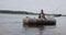 Beautiful cinematic shot. Girl fisherman rowing oars on lake an inflatable boat.