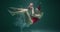 Beautiful cinematic underwater view, happy smiling young woman in red swimming suit holds Christmas gifts slow motion.