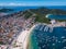 Beautiful city Arraial do Cabo Brazil. Praia dos Anjos. Aerial drone photo from above. Mountains ocean and fishing boats