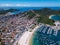 Beautiful city Arraial do Cabo Brazil. Praia dos Anjos. Aerial drone photo from above. Mountains ocean and fishing boats