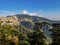 beautiful city escape on mountains and trees in the foreground under blue sky