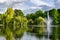 Beautiful city gardens and park with a pond and geyser fountain