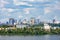 The beautiful cityscape of Kyiv with the Dnipro River, an industrial complex on the bank and new high-rise buildings on the