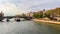 Beautiful cityscape of Paris, bridge Pont Sully across Seine river and a ship. France. April 2019