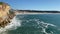 Beautiful cityscape view of Nazare Portugal village in the winter as the waves lap up on the beach