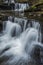 Beautiful claming landscape image of Scaleber Force waterfall in Yorkshire Dales in England during Winter morning